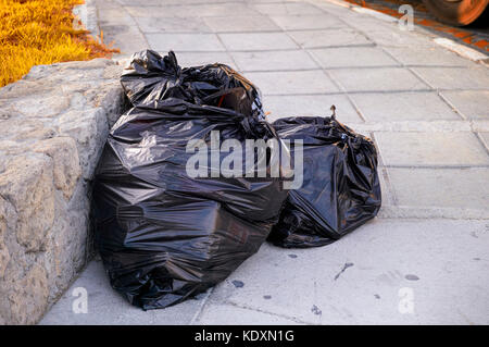 Three big blacks garbage bags full of trash Stock Photo - Alamy