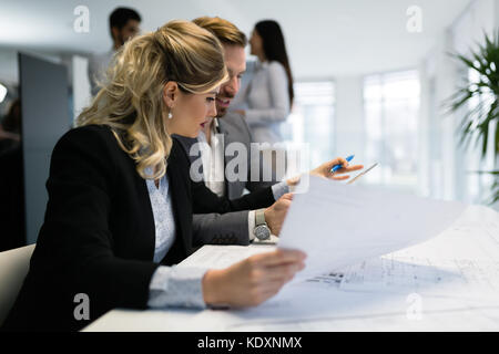 Young attractive architects working on project in office Stock Photo