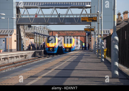 East Midlands Trains class 222 Meridian trains pass at Loughborough with services to/from Sheffield & London St. Pancras Stock Photo