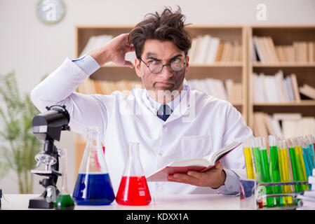 Mad crazy scientist doctor doing experiments in a laboratory Stock Photo