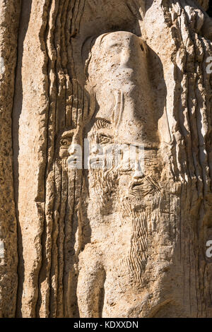 Faces emerging from books in a sculpture commemorating visit by Pope John Paul II to Mount Nebo, Jordan, named Monolith by Vincenzo Bianchi Stock Photo