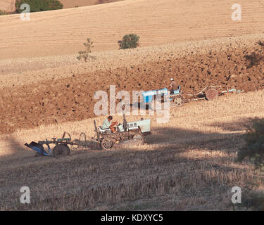 Sant'Eusanio del Sangro, Abruzzo, Italy, August 3 / 2017 Tractors working on the field, tractors ploughing field Stock Photo