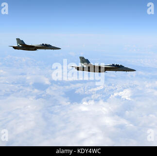 Two modern military jet fighters above mountain tops Stock Photo