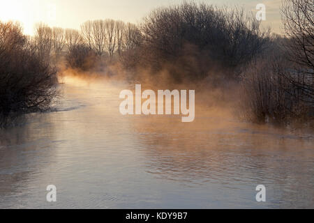 Early morning light and rising mist on the River Wylye, near Great Wishford in Wiltshire. Stock Photo