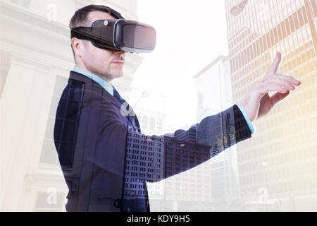 Handsome businessman pressing a button in VR Stock Photo