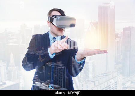 Pleasant businessman interacting with object in virtual reality Stock Photo