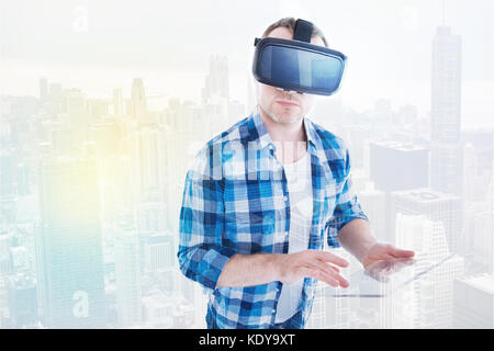 Handsome man in VR headset using tablet Stock Photo