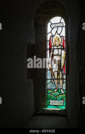 St Michael stained glass window in St Michaels saxon church Duntisbourne rouse, Cotswolds, Gloucestershire, England Stock Photo