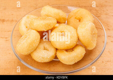 mini sugar coated doughnuts piled on plate hight calorie Stock Photo