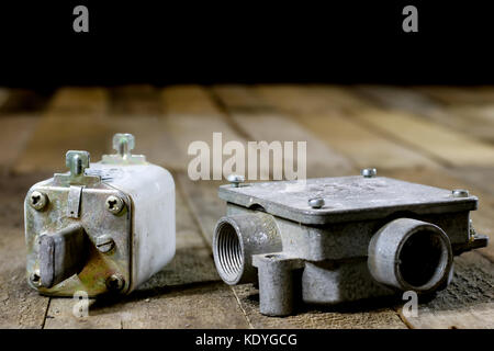 Old ceramic fuse holders. Old electrical accessories. Wooden table, black background Stock Photo