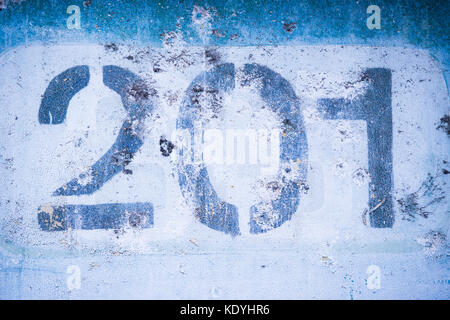 the number 2 0 1 on the blue wall, two hundred and one. Stock Photo