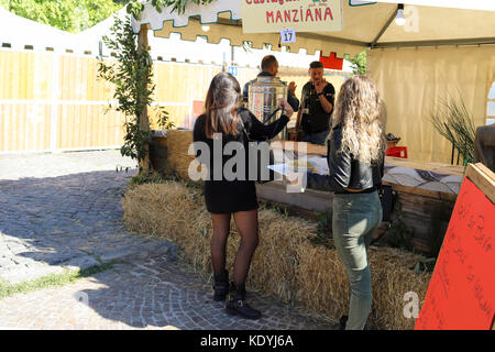 MANZIANA, LAZIO, ITALY - OCTOBER 14, 2017: Two girls buying drinks at stall in outdoors at one of the most popular and awaited local events, the festi Stock Photo