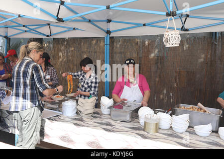 MANZIANA, LAZIO, ITALY - OCTOBER 14, 2017: Women in country kitchen outdoors,  preparing food to serve at the chestnut festival. Stock Photo