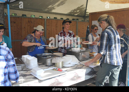 MANZIANA, LAZIO, ITALY - OCTOBER 14, 2017: Women preparing and serving food in outdoors stall at one of the most popular and awaited local events, the Stock Photo