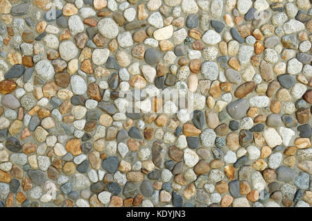 concrete wall with washed cobble texture background Stock Photo