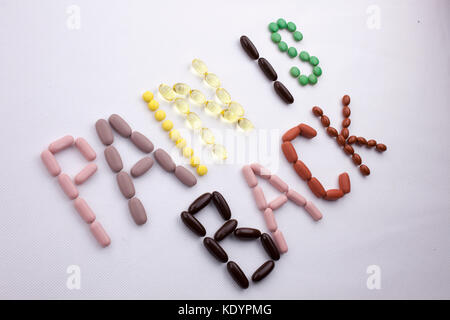 Conceptual Hand writing text caption inspiration Medical care Health concept written with pills drugs capsule word PAIN IS BACK season On white isolat Stock Photo