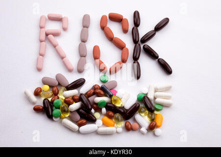 Conceptual Hand writing text caption inspiration Medical care Health concept written with pills drugs capsule word RISK On white isolated background w Stock Photo