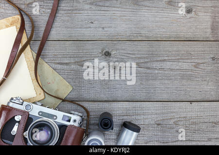 retro still camera and empty instant paper on wooden background flat view Stock Photo