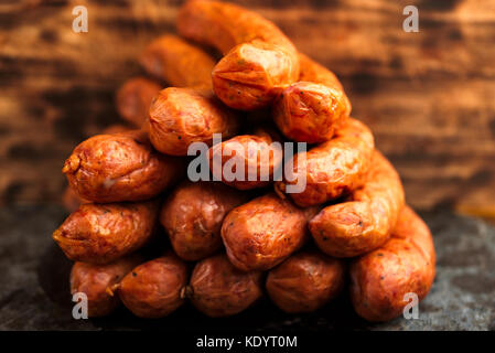 Stack of deliciously smoked handmade Swedish Isterband sausages with natural casing. Stock Photo