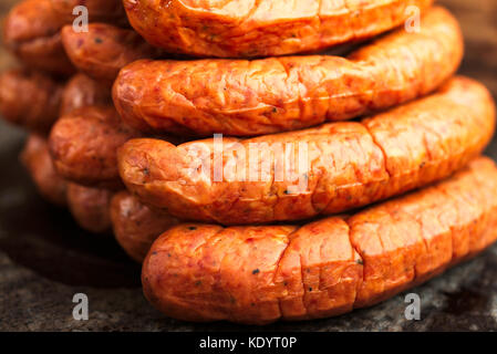 Stack of deliciously smoked handmade Swedish Isterband sausages with natural casing. Stock Photo