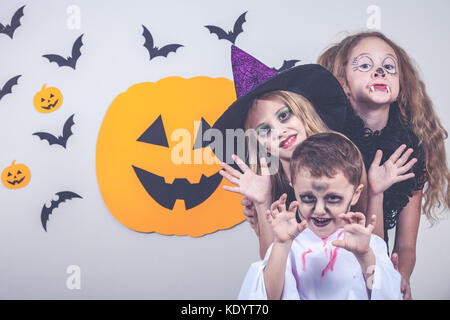 Happy brother and two sisters on Halloween party Stock Photo