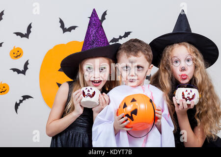 Happy brother and two sisters on Halloween party Stock Photo