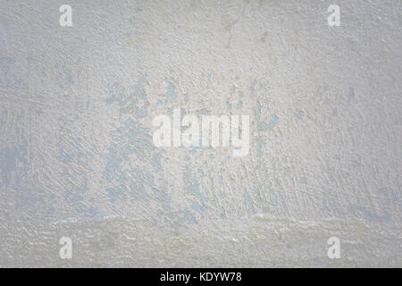 An old painted concrete monument wall without repair. Abstract natural pattern texture with cracking and multicolor peeling. Soft tone. Stock Photo