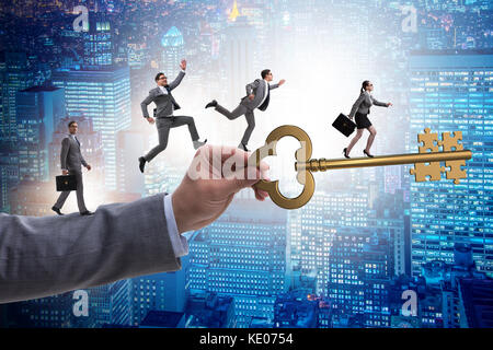 Business people chasing each other towards key to success Stock Photo