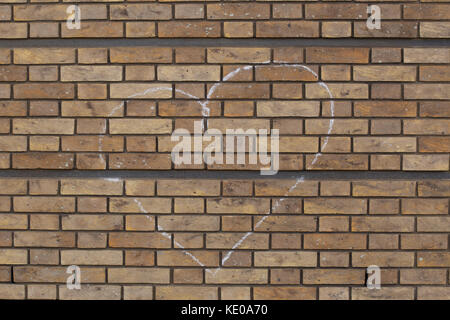 heart drawn in chalk on a brick wall Stock Photo