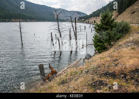 Earthquake Lake, Montana, formed after the devasating earthquake. The mountain that collapsed can be seen in the distance Stock Photo