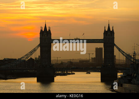 London, UK. 17th Oct, 2017. UK weather. A hazy sunrise behind Tower Bridge on the River Thames this morning. London is experiencing poor air quality and pollution following Storm Ophelia, which has brought Saharan dust and particles from fires in Europe to the capital. Credit: Vickie Flores/Alamy Live News Stock Photo