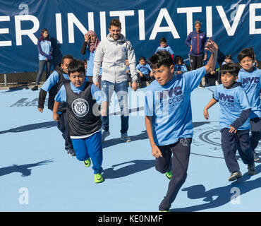 New York, United States. 17th Oct, 2017. New York, NY - October 17, 2017: NYC FC forward David Villa plays with kids during opening of first ten soccer fields as part of New York City soccer initiative at PS 83/PS 182 in Harlem Credit: lev radin/Alamy Live News Stock Photo