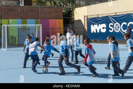 New York, United States. 17th Oct, 2017. New York, NY - October 17, 2017: NYC FC forward David Villa plays with kids during opening of first ten soccer fields as part of New York City soccer initiative at PS 83/PS 182 in Harlem Credit: lev radin/Alamy Live News Stock Photo