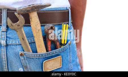 Various hand tools in man's jeans back pocket. Stock Photo