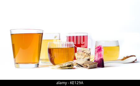 Various herbal teas in glass cups on white background Stock Photo