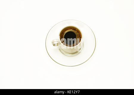 A cup of coffee on a glass transparent saucer on a white background Stock Photo
