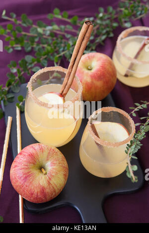 Fruity cocktail with apple and cinnamon sticks Stock Photo