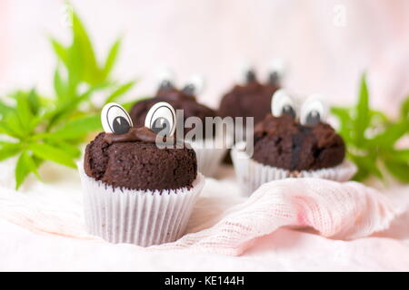 Chocolate muffins with marijuana and edible eyes in paper holders Stock Photo