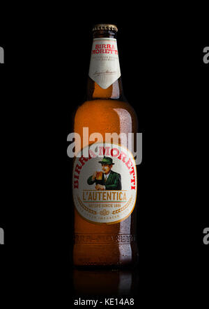 LONDON, UK - MAY 15, 2017: Bottle of Birra Moretti beer on black background, Italian brewing company, founded in Udine in 1859 by Luigi Moretti Stock Photo