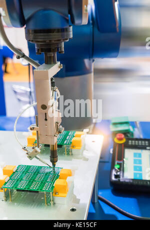 automated Printed Circuit Board (PCB) assembly machine in action ...