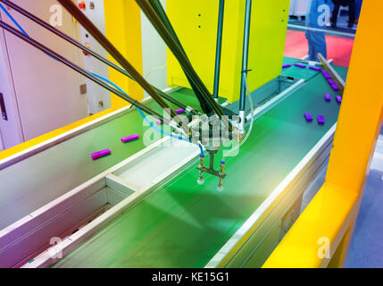 robot with vacuum suckers picks the item from the conveyor in manufacture factory Stock Photo