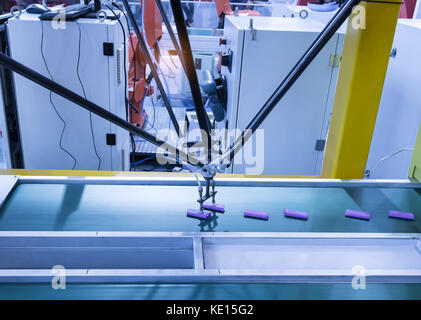 robot with vacuum suckers picks the item from the conveyor in manufacture factory Stock Photo