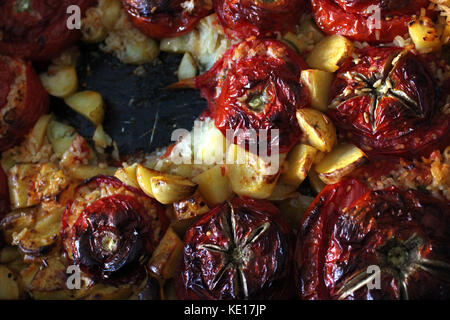 Italian rice stuffed tomatoes with potatoes Stock Photo