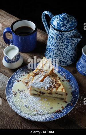 Jumbo french toast stuffed with bananas, roasted pecans and caramel on rustic background Stock Photo