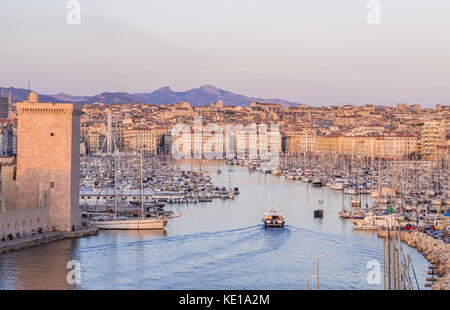 MARSEILLE, FRANCE - AUGUST 07, 2017: The old Vieux Port of Marseille beneath Cathedral of Notre Dame, France, at sunset. Stock Photo