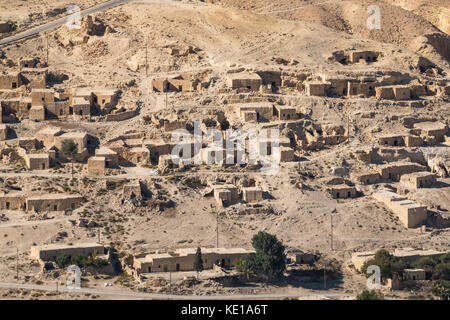 View on Kings Highway of desert valley with mud brick houses in a village, Jordan, Middle East Stock Photo