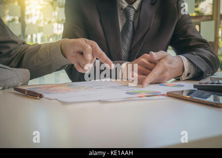Two businessmen looking at report and having a discussion in office. business concept. Stock Photo