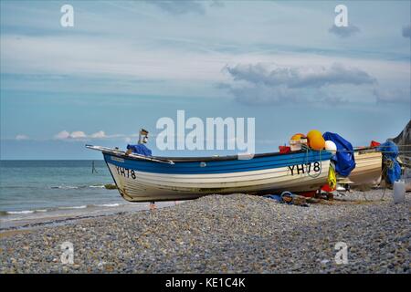 Small fishing boats on the shingle beach at Sheringham Stock Photo