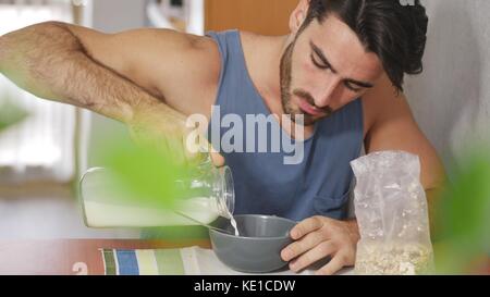 Attractive Young Man Eating Breakfast Stock Photo