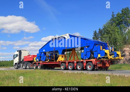 PAIMIO, FINLAND - JUNE 4, 2016: White Volvo FH16 750 transports a shipyard crane bogie on trailer. The weight of the load is 48 tonnes. Stock Photo